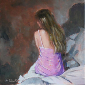 Model at the edge of a bed